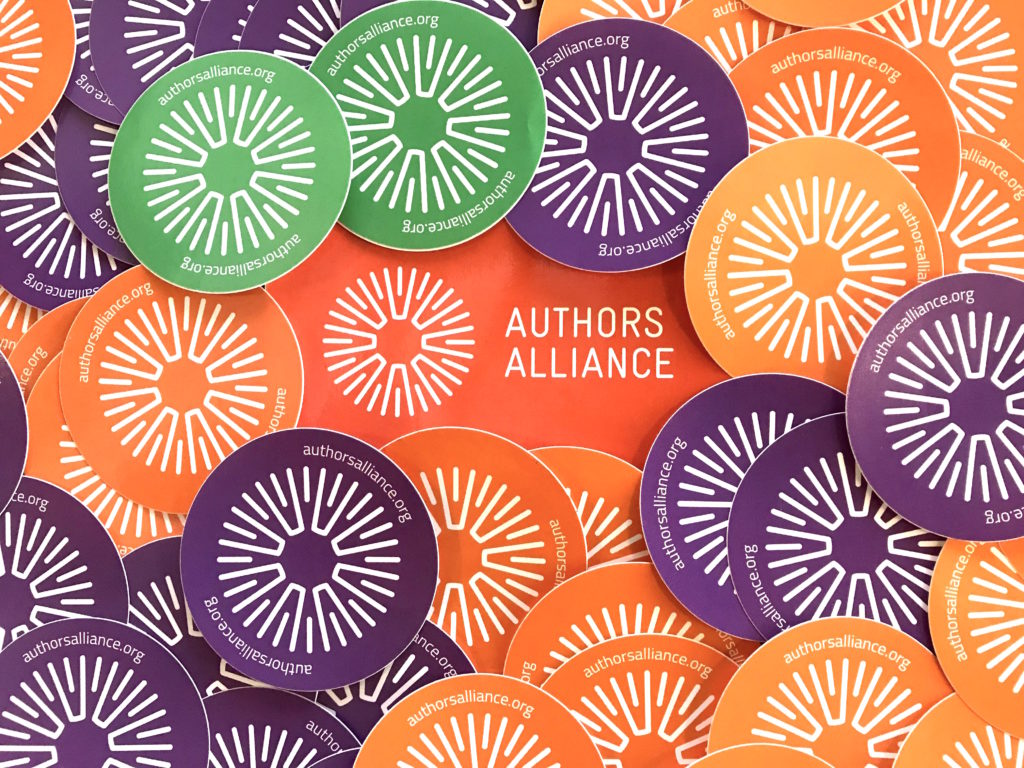 Photo of Authors Alliance logo stickers in orange, green, and purple