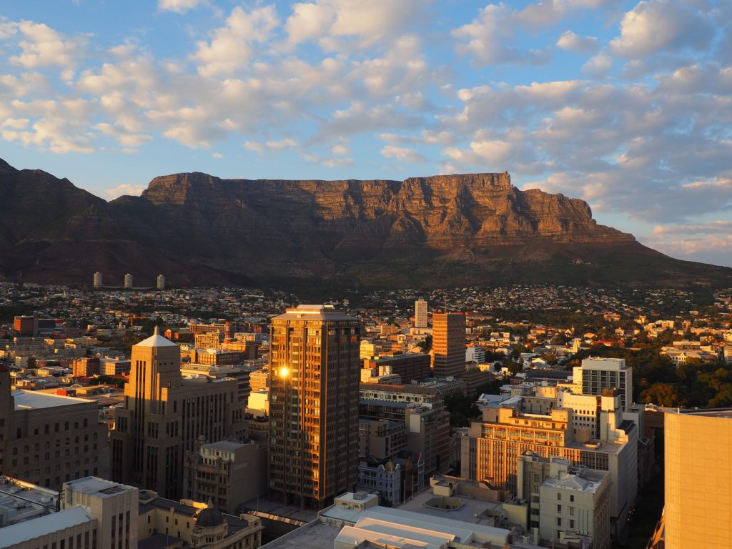 photograph of Cape Town with buildings in foreground and Table Mountain in background