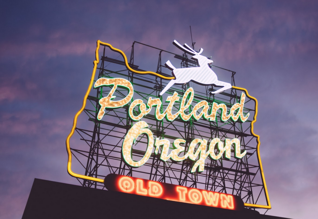 Old Town Portland neon sign against an evening sky