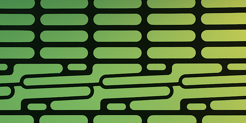 Abstract pattern of green oblong shapes on black background