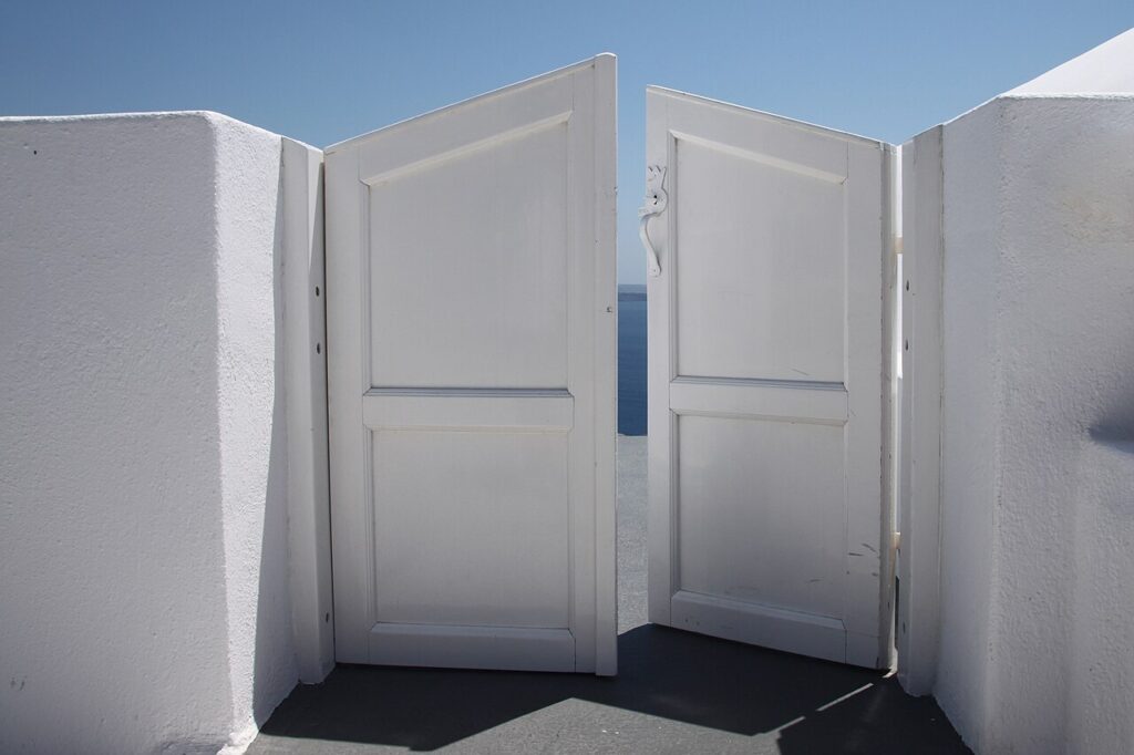 Half-open_door_to_Heaven_(4761478827) white double door, partially open